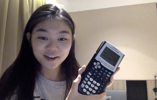 student holding a calculator